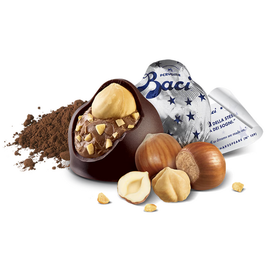 Chocolate truffle with hazelnuts and a Baci Perugina packaging on a white background
